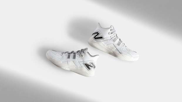Side view of Coco Gauff's white and black New Balance tennis shoes.